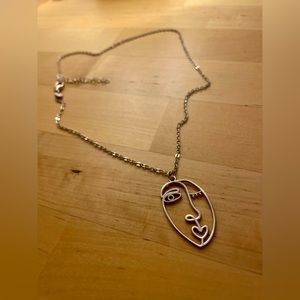 Sterling silver abstract face necklace.